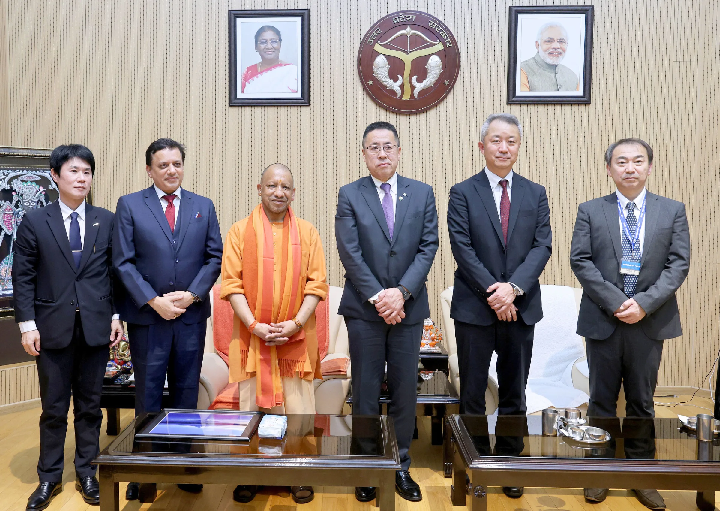 Chief Minister Yogi Adityanath standing with Japanese government and industry leaders.